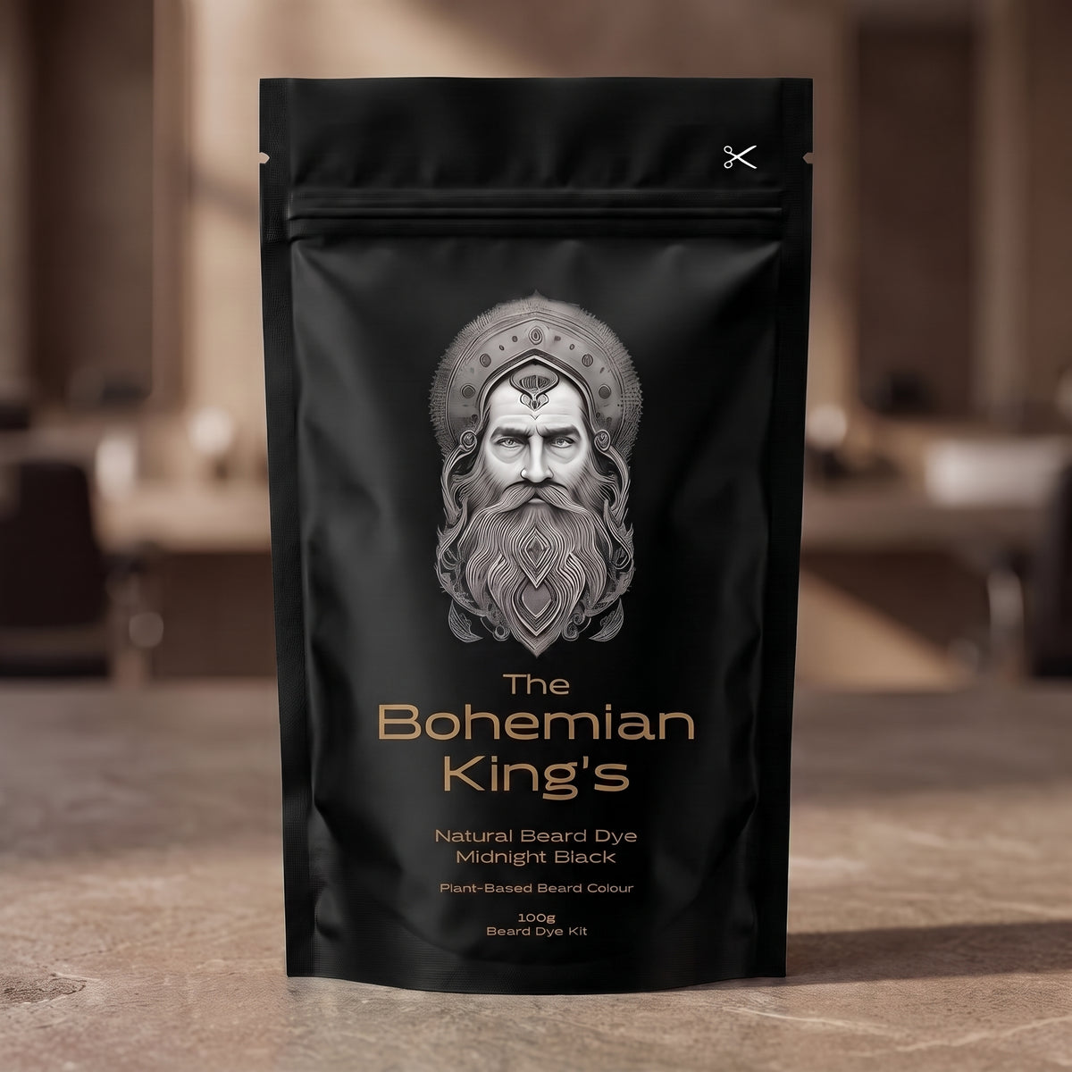A black stand-up pouch of beard dye standing on a stone surface with a blurred indoor background. The front label shows a silver illustrated beard portrait and the text 'The Bohemian King's Natural Beard Dye Midnight Black' with gold-toned lettering.